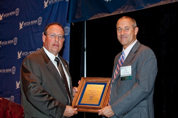 Chris Cusano (l), chapter president, presents the Super NOVA Award to Mark Thomas, director, business development, IP Network Solutions Incorporated, at the September meeting.